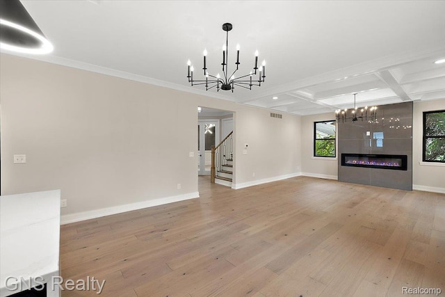 206 E Windemere Ave, Royal Oak, MI 48073 - unfurnished living room featuring a chandelier, coffered ceiling, light wood-type flooring, stairs, and beamed ceiling