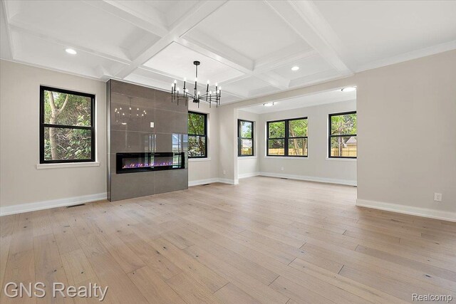 206 E Windemere Ave, Royal Oak, MI 48073 - unfurnished living room with coffered ceiling, light wood-style flooring, plenty of natural light, recessed lighting, and a chandelier