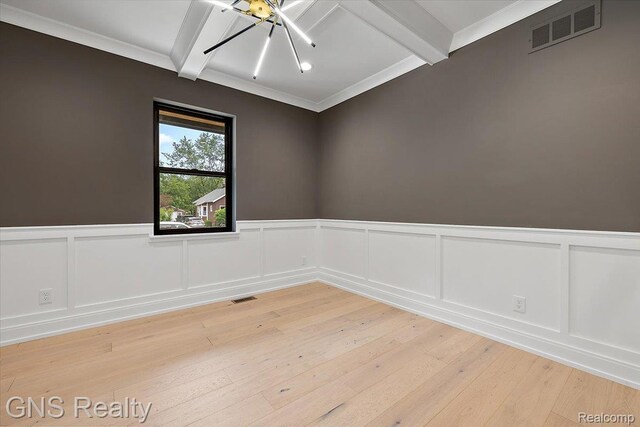 206 E Windemere Ave, Royal Oak, MI 48073 - empty room with beamed ceiling, a chandelier, light wood-style flooring, wainscoting, and a decorative wall