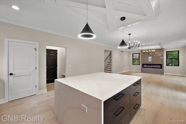 206 E Windemere Ave, Royal Oak, MI 48073 - kitchen featuring coffered ceiling, light wood-type flooring, a center island, hanging light fixtures, and a chandelier