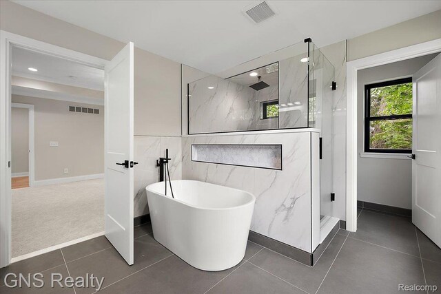206 E Windemere Ave, Royal Oak, MI 48073 - bathroom featuring a marble finish shower, a freestanding tub, tile walls, recessed lighting, and tile patterned floors