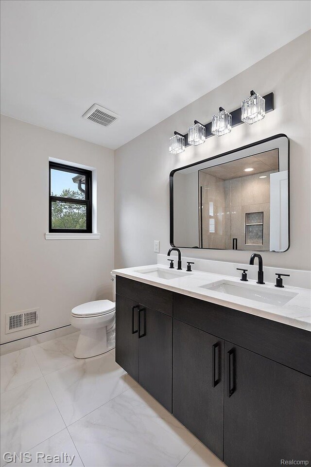 206 E Windemere Ave, Royal Oak, MI 48073 - full bath with double vanity, marble look tiles, and toilet