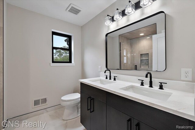206 E Windemere Ave, Royal Oak, MI 48073 - bathroom with toilet, double vanity, a tile shower, marble look tiles, and recessed lighting