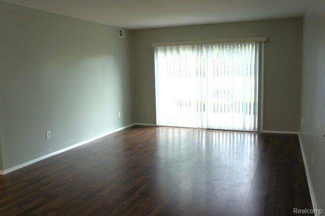 966 Bloomfield Village Blvd, Auburn Hills, MI 48326 - empty room featuring baseboards and dark wood-type flooring