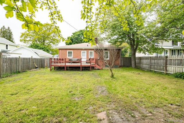 2028 9th St, Port Huron, MI 48060 - rear view of house with brick siding, a deck, and a chimney