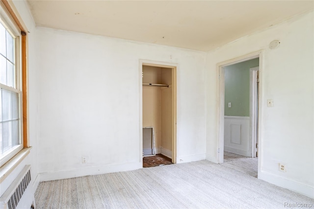 2028 9th St, Port Huron, MI 48060 - unfurnished bedroom featuring radiator heating unit, carpet floors, and a closet