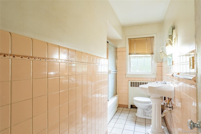 2028 9th St, Port Huron, MI 48060 - full bath with tile walls, tile patterned flooring, toilet, shower / washtub combination, and radiator heating unit