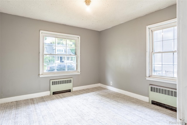 2028 9th St, Port Huron, MI 48060 - carpeted empty room with radiator, baseboards, and a textured ceiling