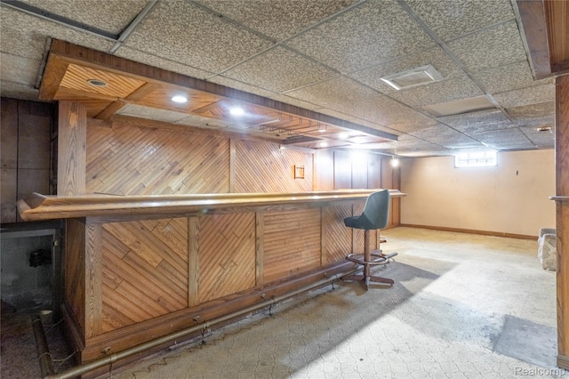 2028 9th St, Port Huron, MI 48060 - indoor dry bar featuring wood walls, baseboards, and a drop ceiling