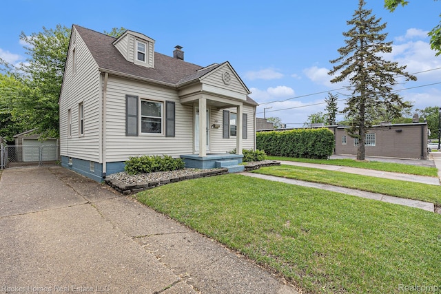 30 Charlevoix St, Clawson, MI 48017 - view of front of property with a front lawn, an outdoor structure, a chimney, a shingled roof, and a detached garage