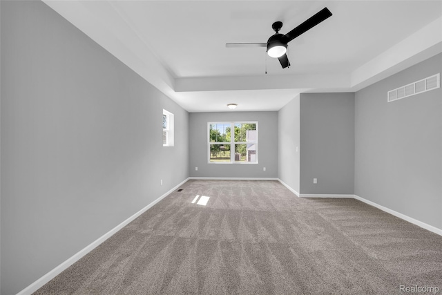 10705 Deer Ridge Trl, Rose, MI 48442 - carpeted spare room with ceiling fan, baseboards, and a raised ceiling