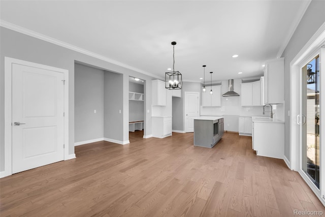 10705 Deer Ridge Trl, Rose, MI 48442 - unfurnished living room featuring crown molding, a chandelier, light wood finished floors, recessed lighting, and baseboards