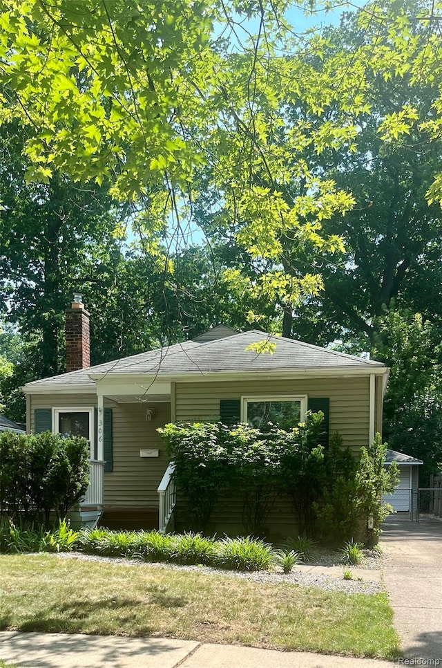 306 N Vermont Ave, Royal Oak, MI 48067 - view of home's exterior featuring a chimney, covered porch, and an outbuilding