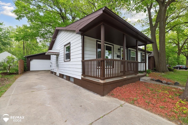 3825 Craig Dr, Flint, MI 48506 - view of front facade featuring a porch, a detached garage, and an outdoor structure