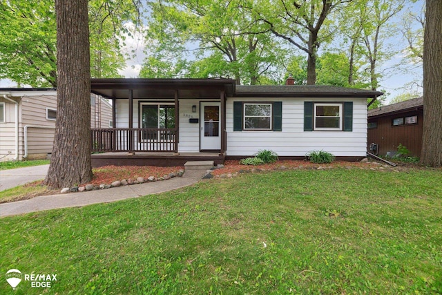 3825 Craig Dr, Flint, MI 48506 - ranch-style home featuring covered porch, a front lawn, and a chimney