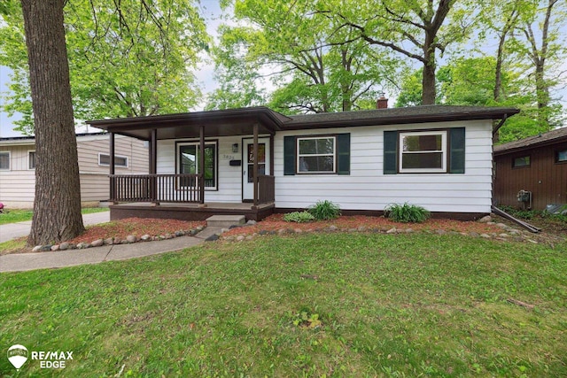 3825 Craig Dr, Flint, MI 48506 - single story home with covered porch, a front yard, and a chimney