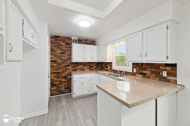 3825 Craig Dr, Flint, MI 48506 - kitchen with a peninsula, decorative backsplash, and white cabinets