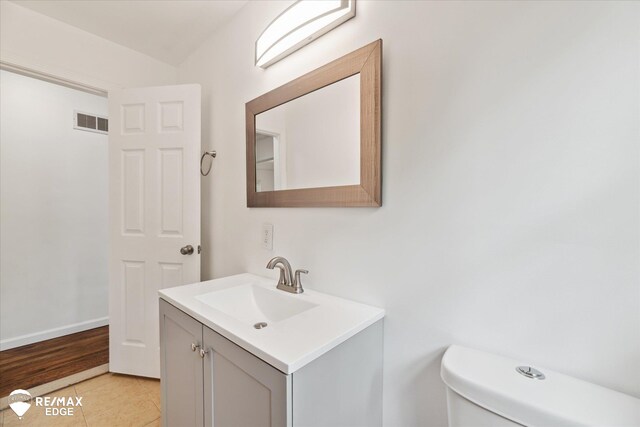 3825 Craig Dr, Flint, MI 48506 - half bathroom featuring vanity, toilet, and tile patterned flooring