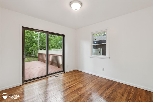 3825 Craig Dr, Flint, MI 48506 - empty room featuring wood finished floors, plenty of natural light, and baseboards
