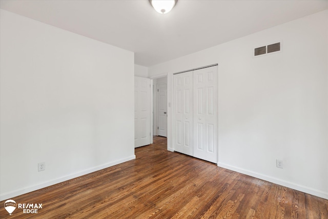 3825 Craig Dr, Flint, MI 48506 - unfurnished bedroom with baseboards, wood finished floors, and a closet