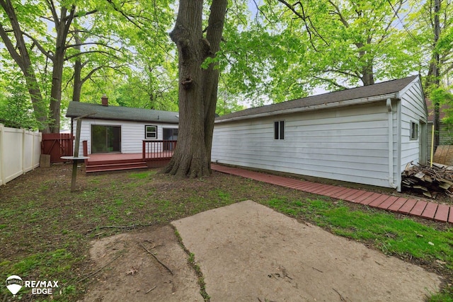 3825 Craig Dr, Flint, MI 48506 - back of property featuring a wooden deck and a patio area