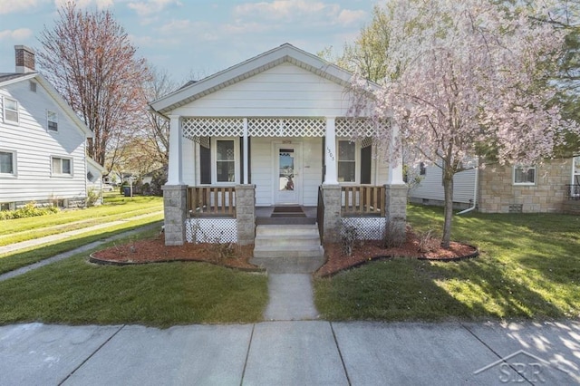 1303 S Warner St, Bay City, MI 48706 - view of front of house with covered porch and a front lawn