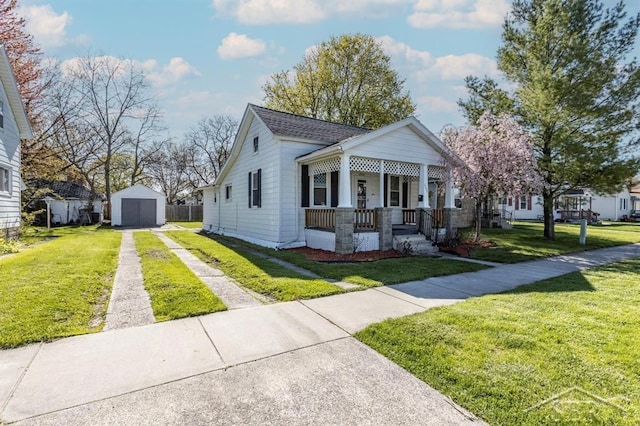 1303 S Warner St, Bay City, MI 48706 - bungalow-style house with covered porch, driveway, a garage, and a front yard