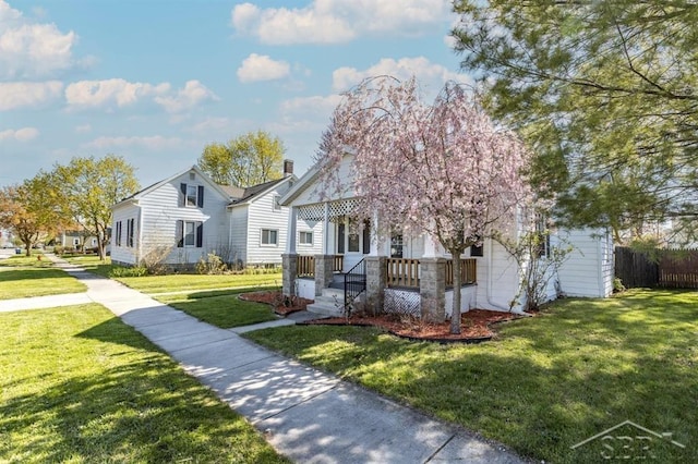 1303 S Warner St, Bay City, MI 48706 - view of front of home with covered porch and a chimney