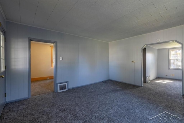 1303 S Warner St, Bay City, MI 48706 - unfurnished room featuring carpet flooring and arched walkways