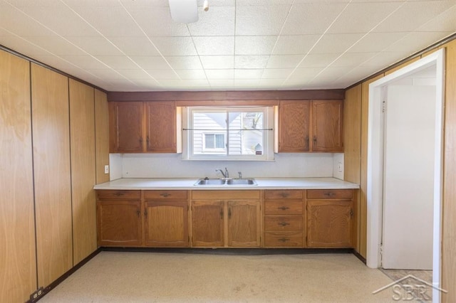 1303 S Warner St, Bay City, MI 48706 - kitchen with a sink, brown cabinetry, and light countertops
