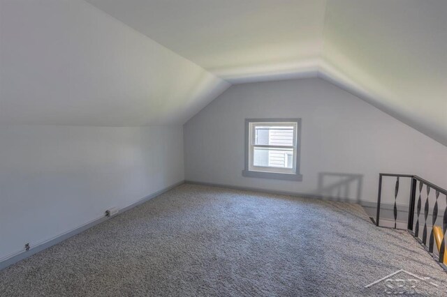 1303 S Warner St, Bay City, MI 48706 - additional living space with carpet flooring, lofted ceiling, and baseboards