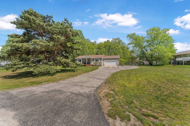 34 Mathison Rd, Traverse City, MI 49686 - ranch-style house with a front lawn, driveway, and a garage