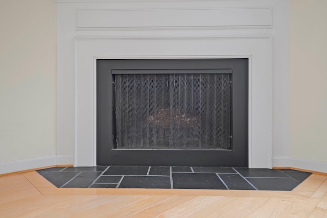 34 Mathison Rd, Traverse City, MI 49686 - detailed view of baseboards and a fireplace with flush hearth