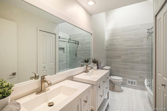 7831 Caberfae Trl, Clarkston, MI 48348 - bathroom with vanity, a stall shower, toilet, recessed lighting, and tile walls