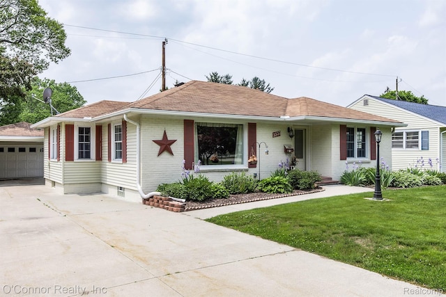 3333 Stone, Port Huron, MI 48060 - ranch-style home featuring an outbuilding, a front yard, brick siding, roof with shingles, and driveway