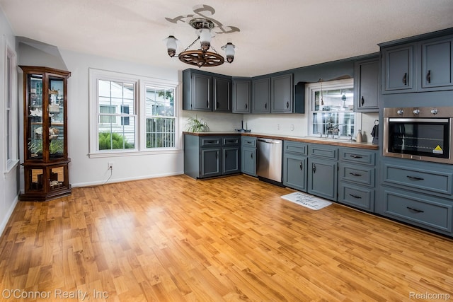 3333 Stone, Port Huron, MI 48060 - kitchen featuring appliances with stainless steel finishes, a chandelier, light wood-type flooring, and baseboards