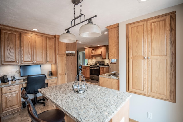 8595 E Napier Ave, Benton Harbor, MI 49022 - kitchen featuring stainless steel gas stove, light stone countertops, recessed lighting, a kitchen island, and a kitchen breakfast bar