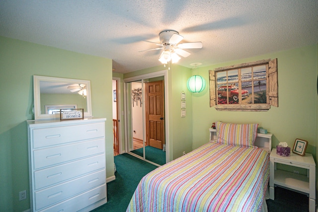 8595 E Napier Ave, Benton Harbor, MI 49022 - bedroom with a closet, a textured ceiling, dark colored carpet, and a ceiling fan