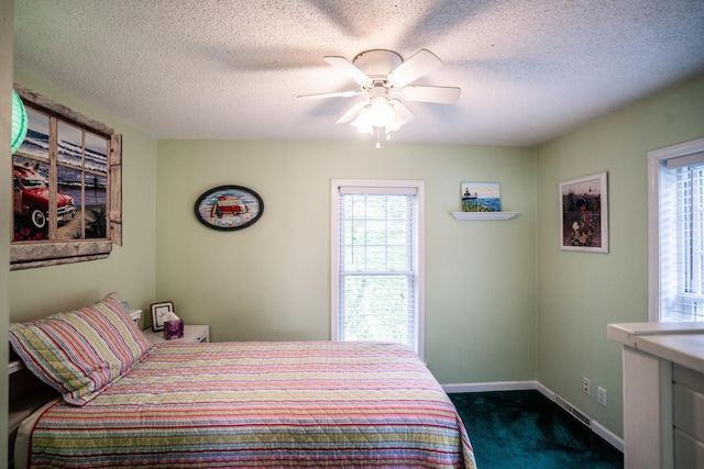 8595 E Napier Ave, Benton Harbor, MI 49022 - bedroom featuring dark colored carpet, baseboards, a textured ceiling, and a ceiling fan