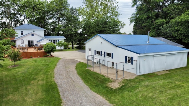 8595 E Napier Ave, Benton Harbor, MI 49022 - view of property exterior featuring driveway, a lawn, and metal roof