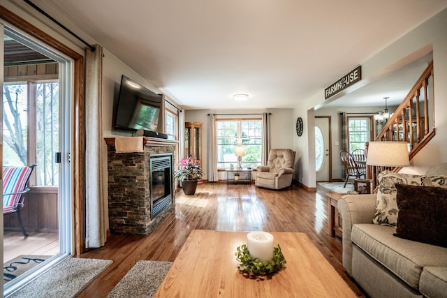 8595 E Napier Ave, Benton Harbor, MI 49022 - living area featuring a stone fireplace, hardwood / wood-style flooring, and a chandelier