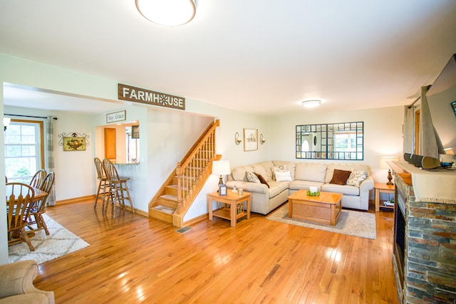8595 E Napier Ave, Benton Harbor, MI 49022 - living room featuring stairs, light wood-style flooring, and baseboards