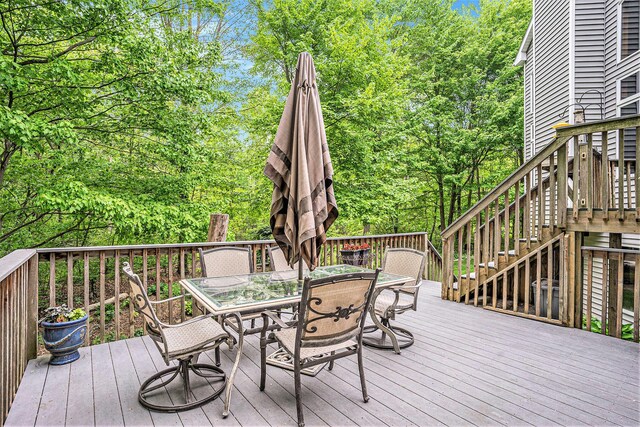 8837 56th Ave, Hudsonville, MI 49426 - wooden terrace with outdoor dining area and stairway