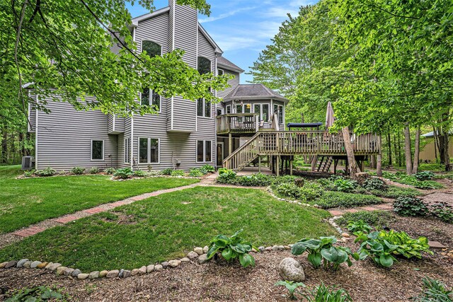 8837 56th Ave, Hudsonville, MI 49426 - back of house with a wooden deck, stairway, a lawn, a chimney, and central AC
