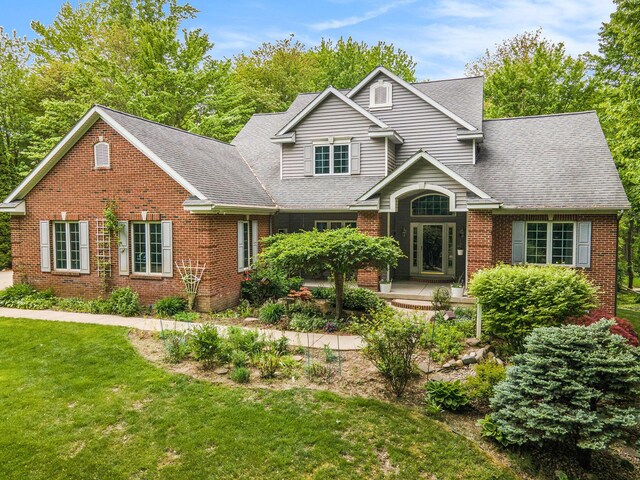 8837 56th Ave, Hudsonville, MI 49426 - traditional-style home with brick siding, a front yard, and a shingled roof