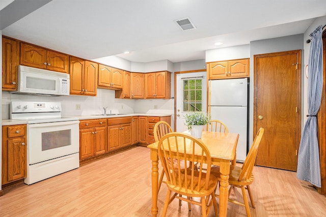 8837 56th Ave, Hudsonville, MI 49426 - kitchen featuring white appliances, a sink, light wood finished floors, light countertops, and recessed lighting