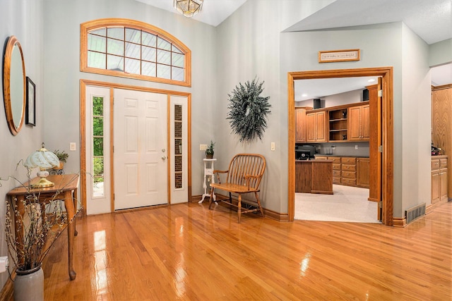8837 56th Ave, Hudsonville, MI 49426 - entryway featuring light wood-style flooring, a high ceiling, and baseboards