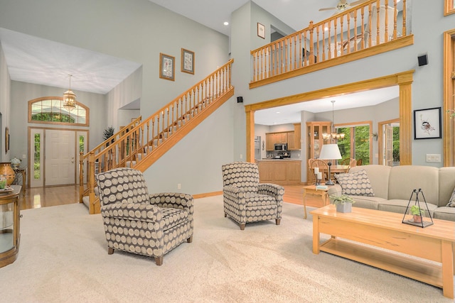 8837 56th Ave, Hudsonville, MI 49426 - carpeted living area featuring a towering ceiling, a chandelier, stairs, baseboards, and recessed lighting