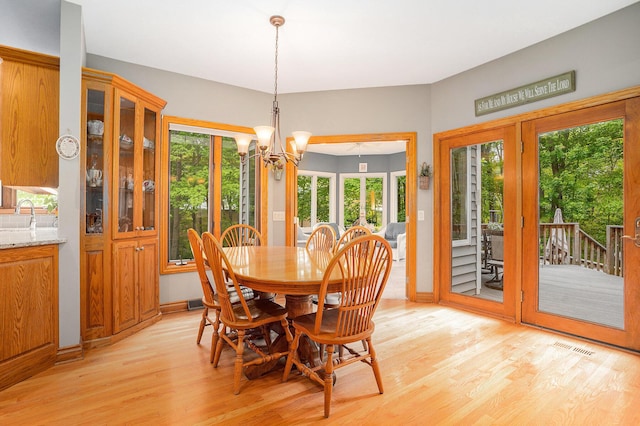 8837 56th Ave, Hudsonville, MI 49426 - dining area with light wood-style floors, healthy amount of natural light, and a chandelier