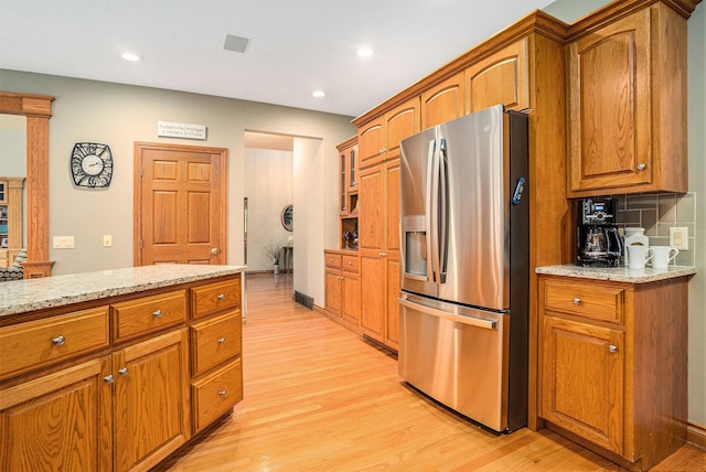 8837 56th Ave, Hudsonville, MI 49426 - kitchen with stainless steel fridge, light wood finished floors, brown cabinets, and recessed lighting